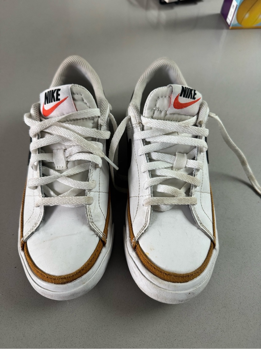 Nike Kids White Sneakers with Brown Trim and Orange Swoosh